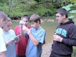 students test water quality in the Red River